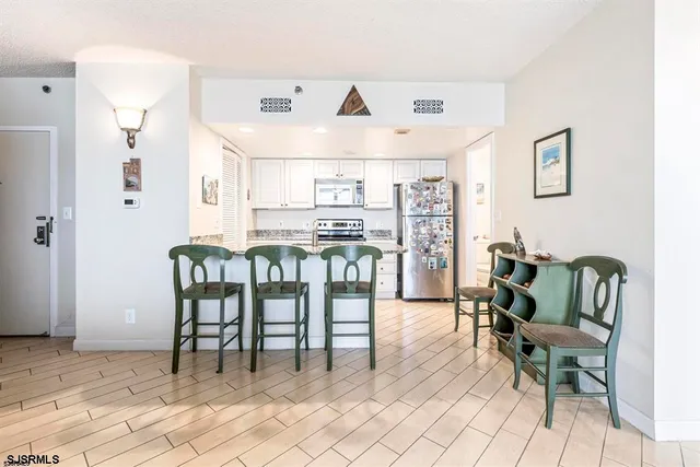 a view of kitchen with dining area and windows