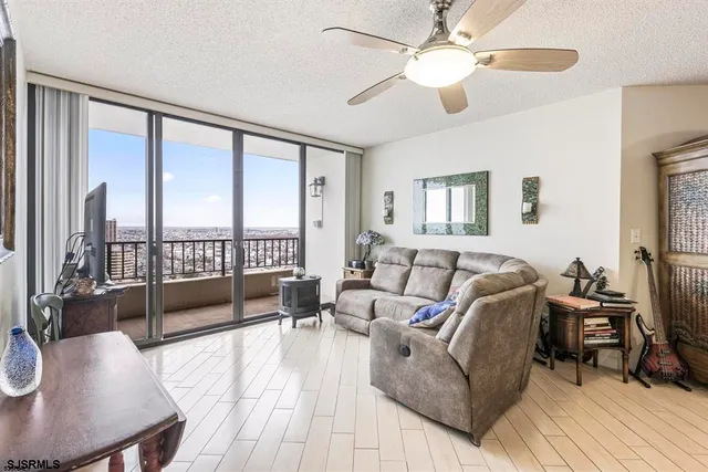 a living room with furniture and a floor to ceiling window