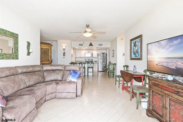 a living room with furniture and kitchen view