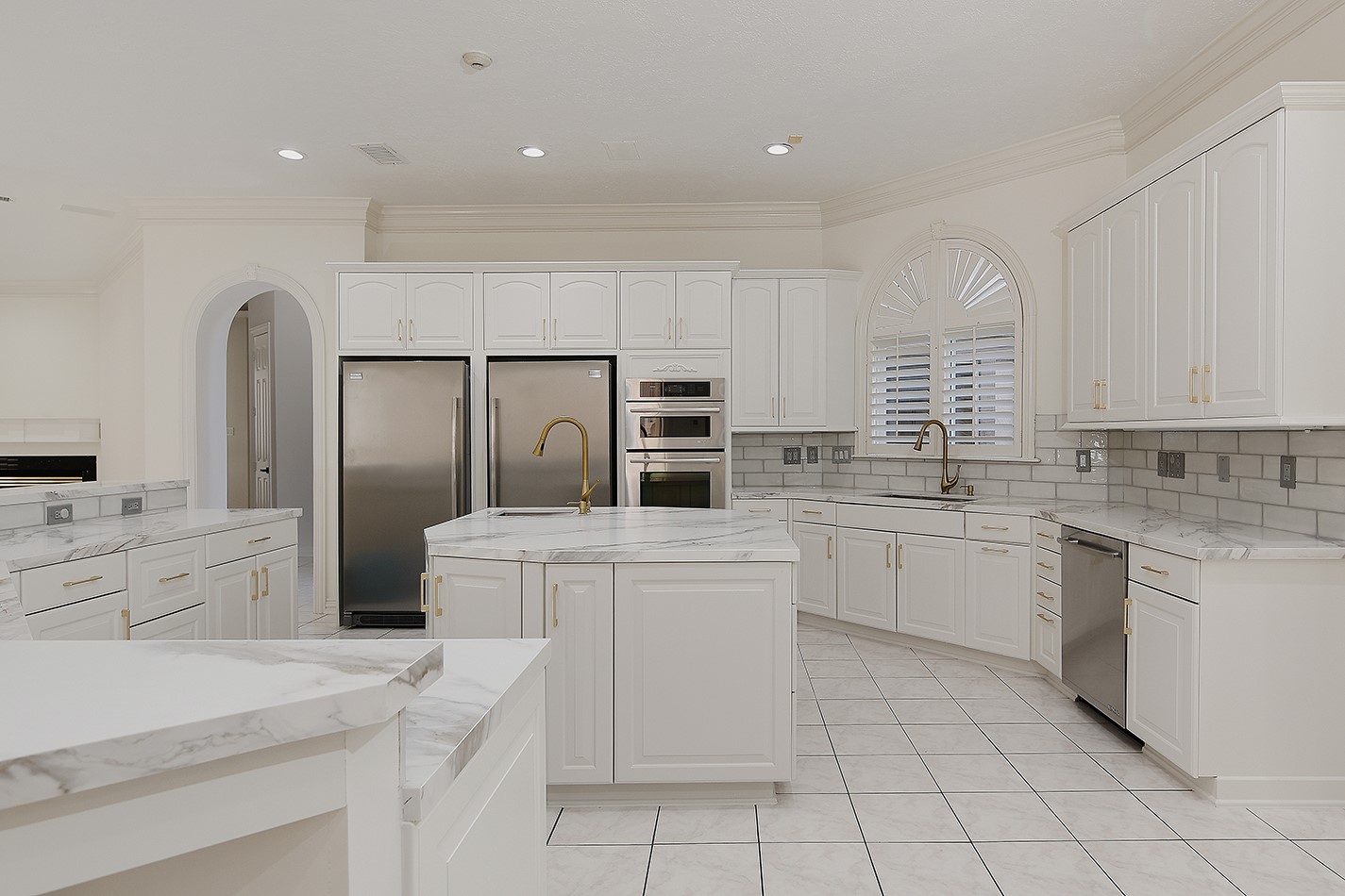 23508 Twin Oaks Drive Spring, TX 77389 - Photo 14 of 50 a kitchen with white cabinets and white appliances