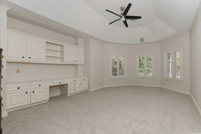 a view of pool with a table and chairs under an umbrella