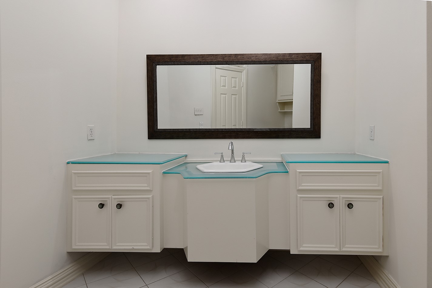 23508 Twin Oaks Drive Spring, TX 77389 - Photo 35 of 50 a bathroom with a sink and a mirror