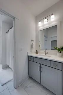 a bathroom with a double vanity sink mirror and