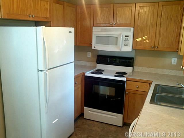 2201 Dawn Ridge Monroe, NC 28110 - Photo 2 of 8 a white refrigerator freezer and a stove sitting inside of a kitchen