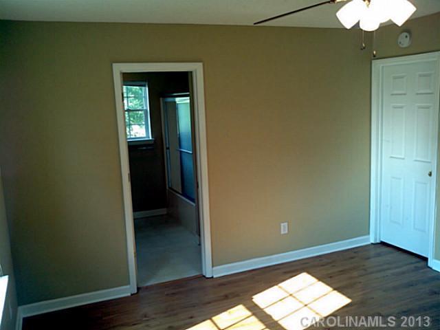 2201 Dawn Ridge Monroe, NC 28110 - Photo 7 of 8 an empty room with wooden floor closet and windows
