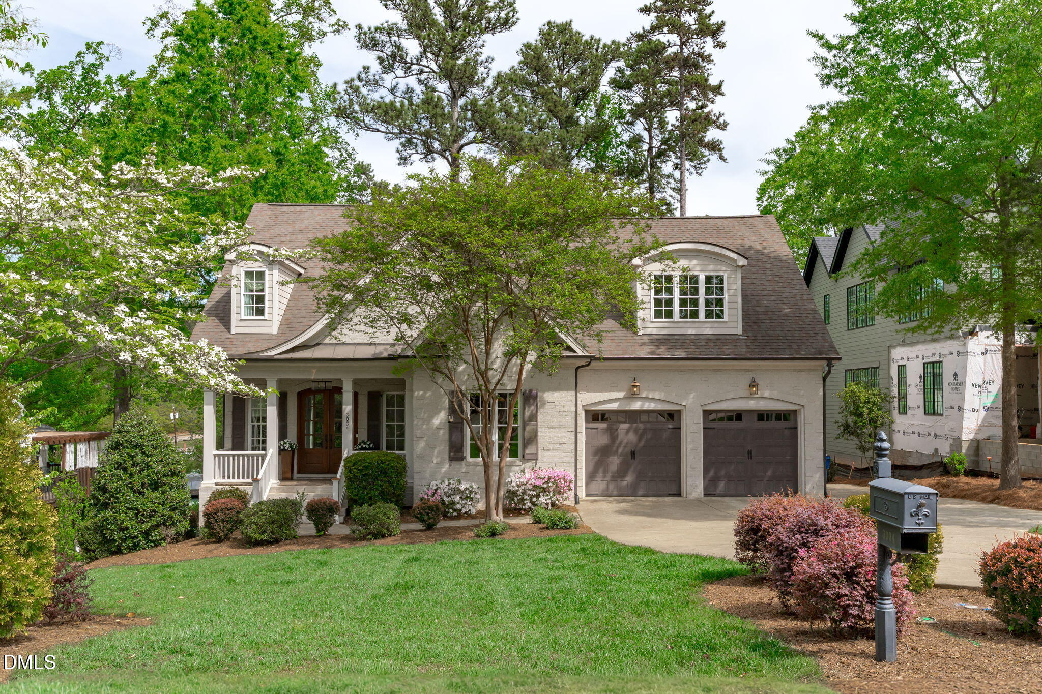 a front view of a house with a garden and porch