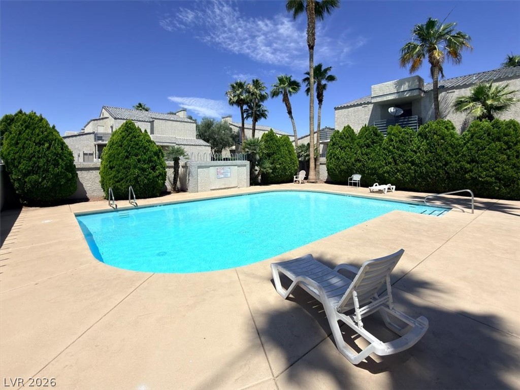 6250 West Flamingo Road, Unit 93 Las Vegas, NV 89103 - Photo 36 of 38 Relax poolside in this inviting community oasis, surrounded by lush landscaping and sunny skies.