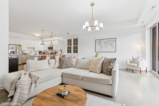 1332 West Madison Street, Unit 3E Chicago, IL 60607 - Photo 2 of 14 a living room with furniture kitchen and a chandelier