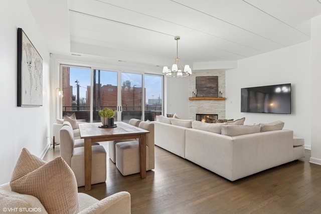 1332 West Madison Street, Unit 3E Chicago, IL 60607 - Photo 3 of 14 a living room with furniture and a flat screen tv
