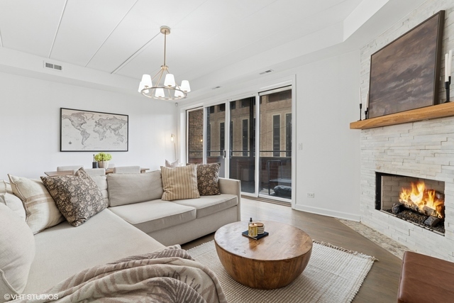 1332 West Madison Street, Unit 3E Chicago, IL 60607 - Photo 4 of 14 a living room with furniture and a fireplace