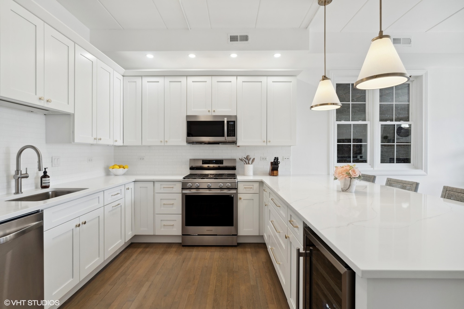 1332 West Madison Street, Unit 3E Chicago, IL 60607 - Photo 6 of 14 a kitchen with stainless steel appliances granite countertop a sink a stove and a wooden floors