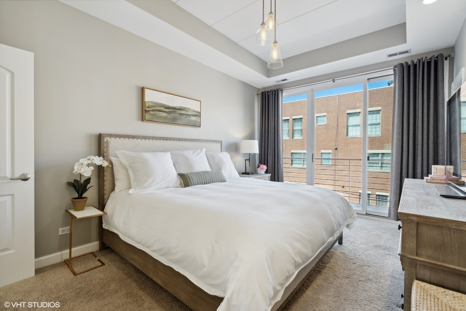1332 West Madison Street, Unit 3E Chicago, IL 60607 - Photo 7 of 14 a bedroom with bed and large windows