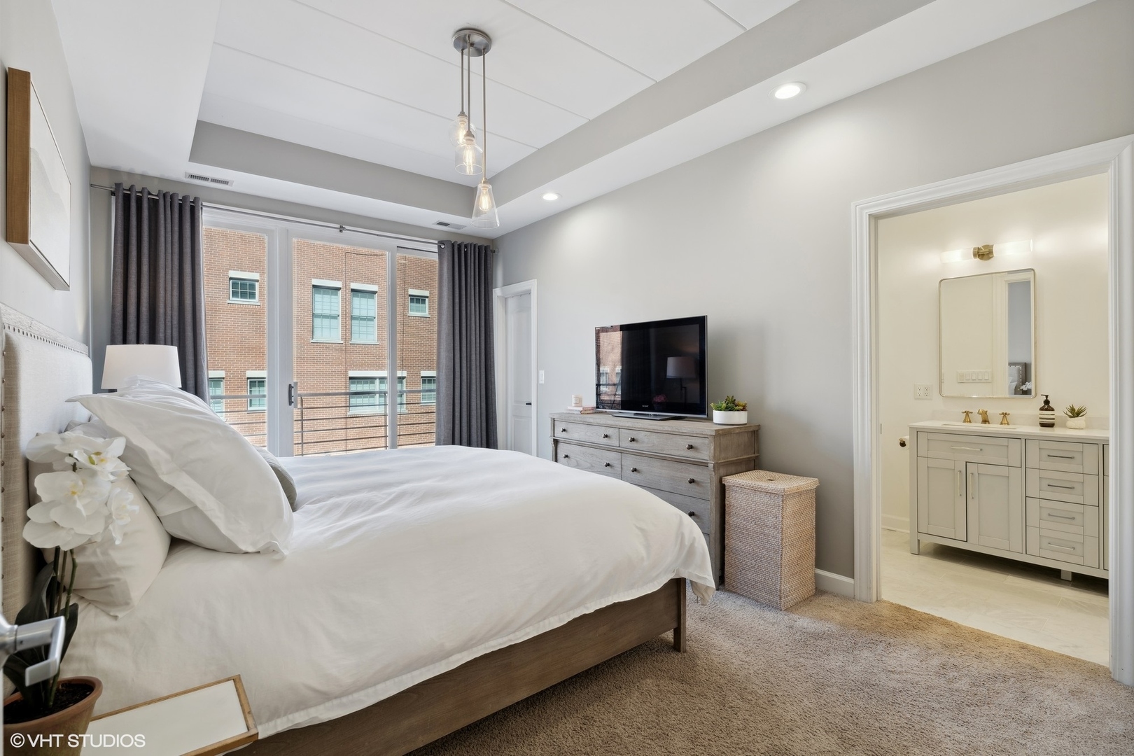 1332 West Madison Street, Unit 3E Chicago, IL 60607 - Photo 8 of 14 a bedroom with a large bed and a flat screen tv