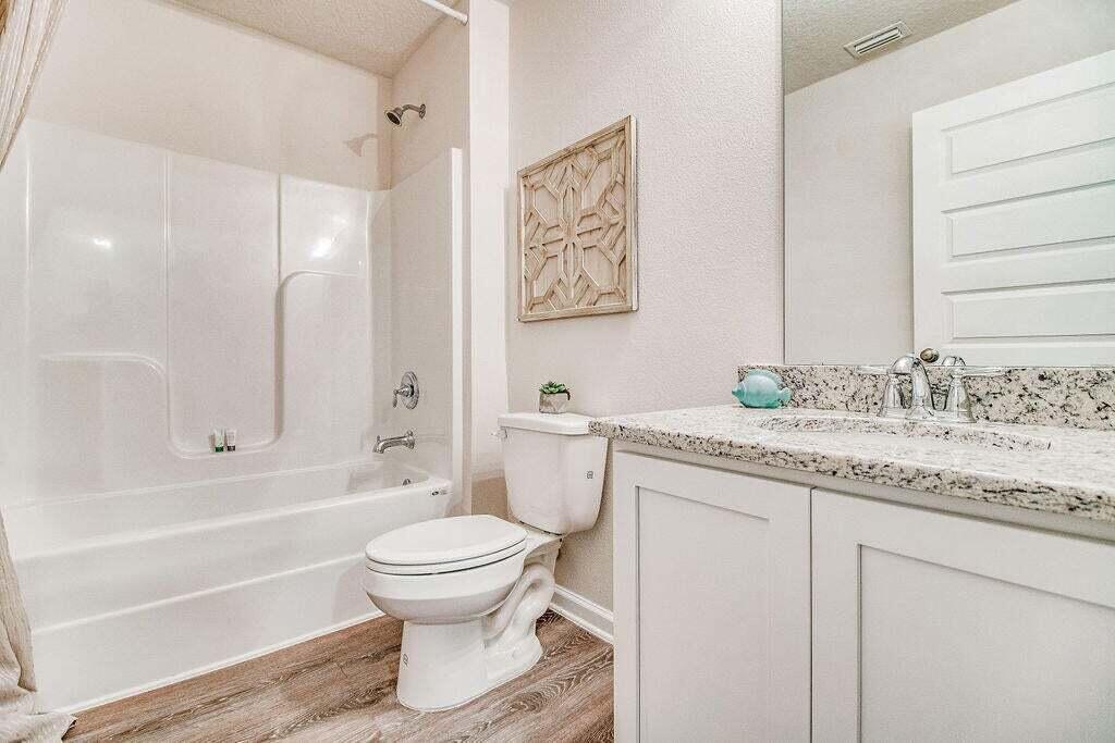 3406 Phoenix Court Crestview, FL 32539 - Photo 24 of 31 a bathroom with a granite countertop sink toilet and shower