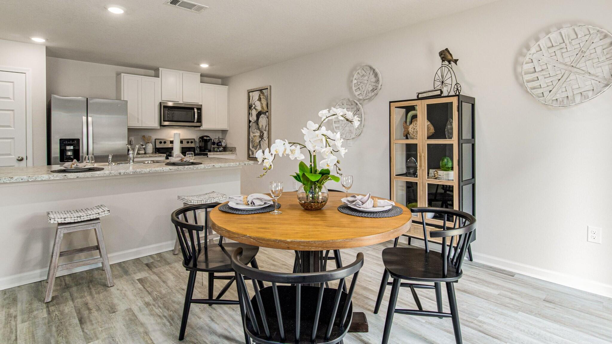 3406 Phoenix Court Crestview, FL 32539 - Photo 4 of 31 a view of a dining room with furniture a chandelier and wooden floor