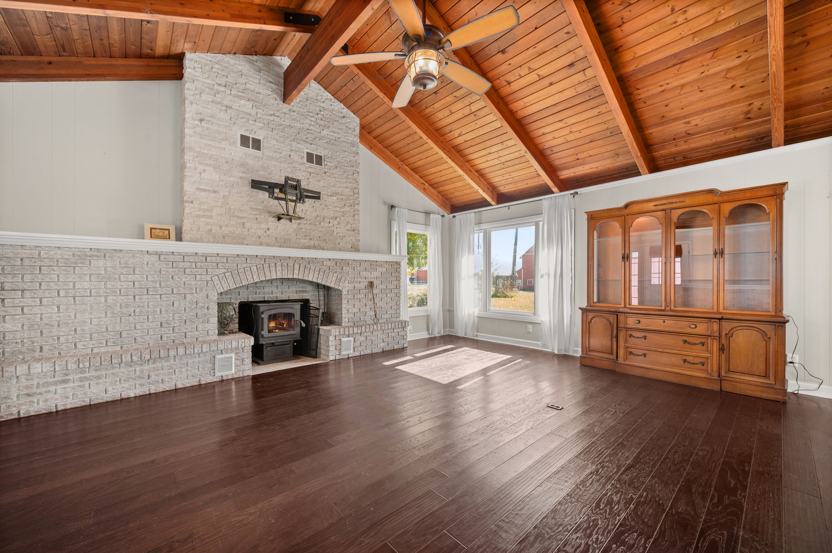 29290 Glidden Road Kingston, IL 60145 - Photo 13 of 38 an empty room with wooden floor fire place and windows