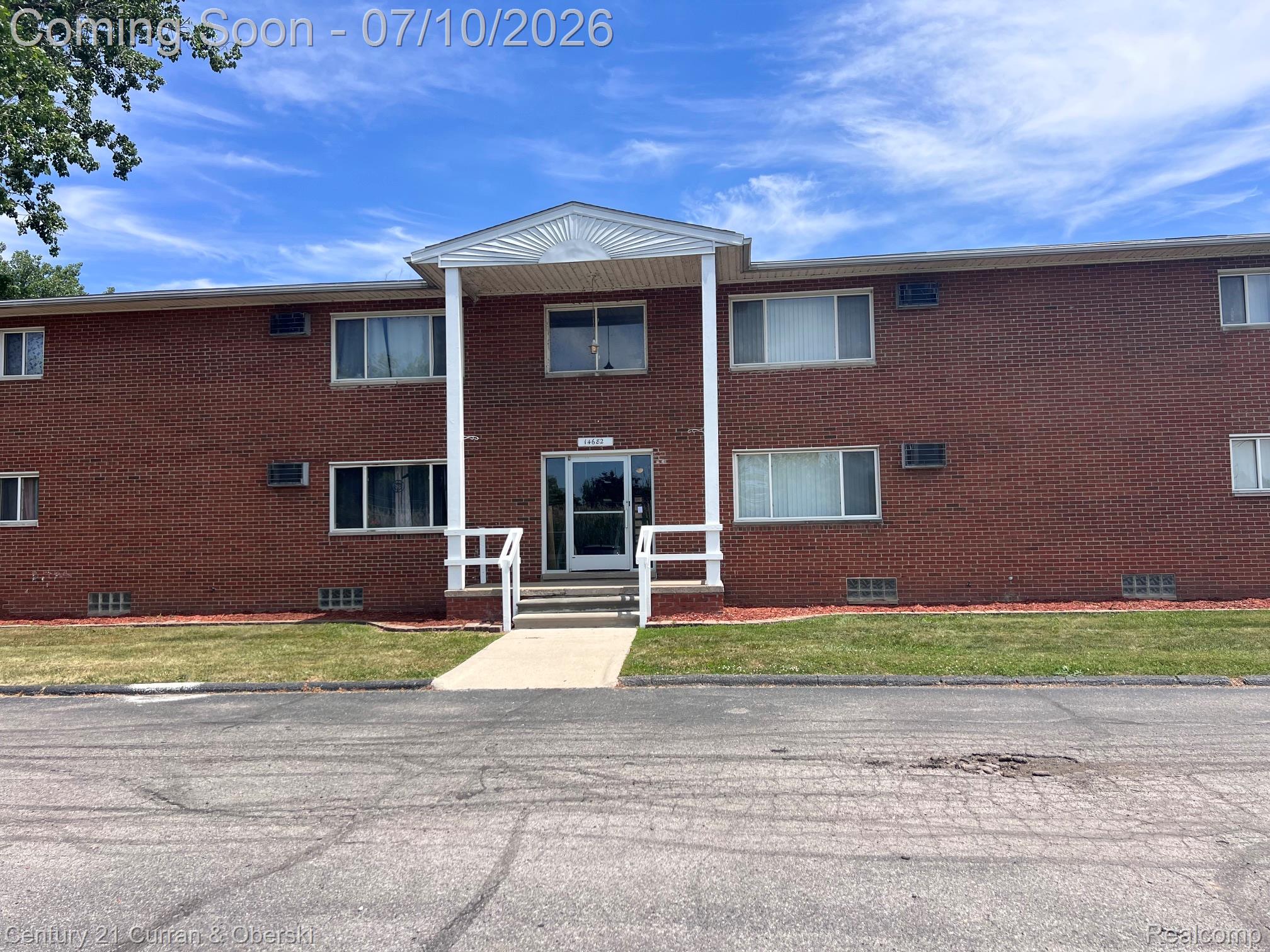 14682 Middle Gibraltar Road, Unit 24 Rockwood, MI 48173 - Photo 2 of 21 Two-story brick exterior building featuring a covered main entrance with white columns and railings