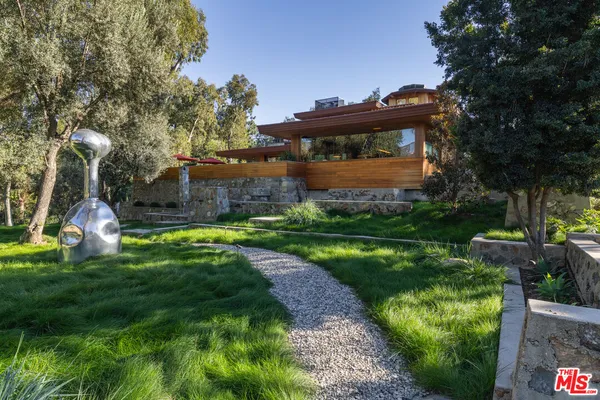 a view of a park with plants and a fountain
