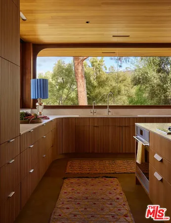 a view of a kitchen with a sink and wooden floor