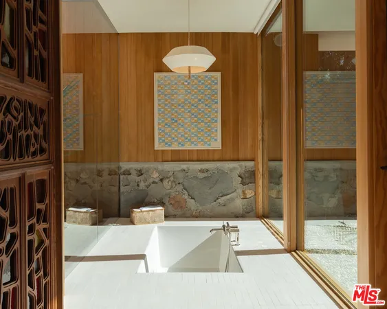 a bathroom with a tub and shower