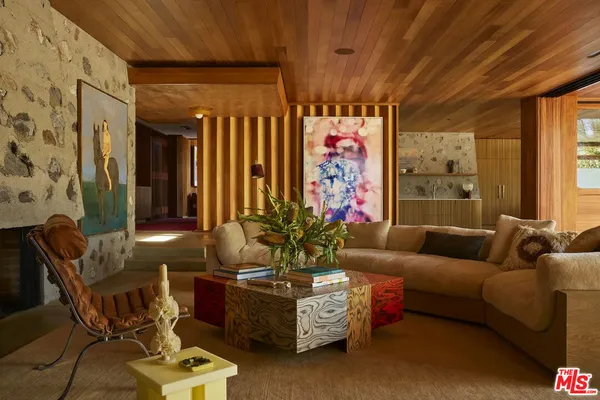 a living room with furniture and flowers