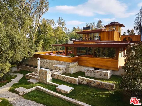 an aerial view of a house with swimming pool garden and patio