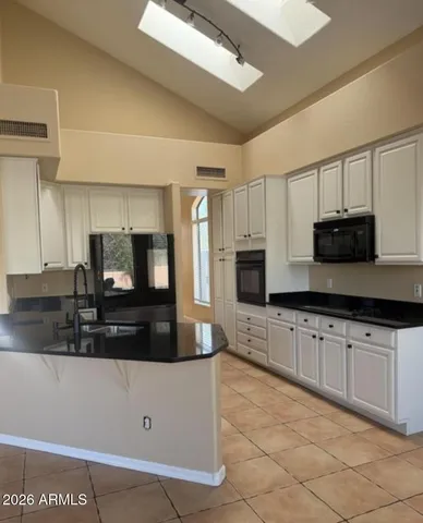 a kitchen with stainless steel appliances a stove microwave and sink