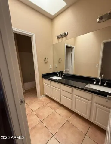 a large bathroom with a double vanity sink and a mirror