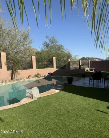 a view of a house with backyard and sitting area