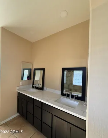a bathroom with a double vanity sink and mirror