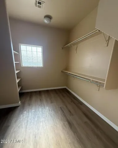 a view of a room with wooden floor and window