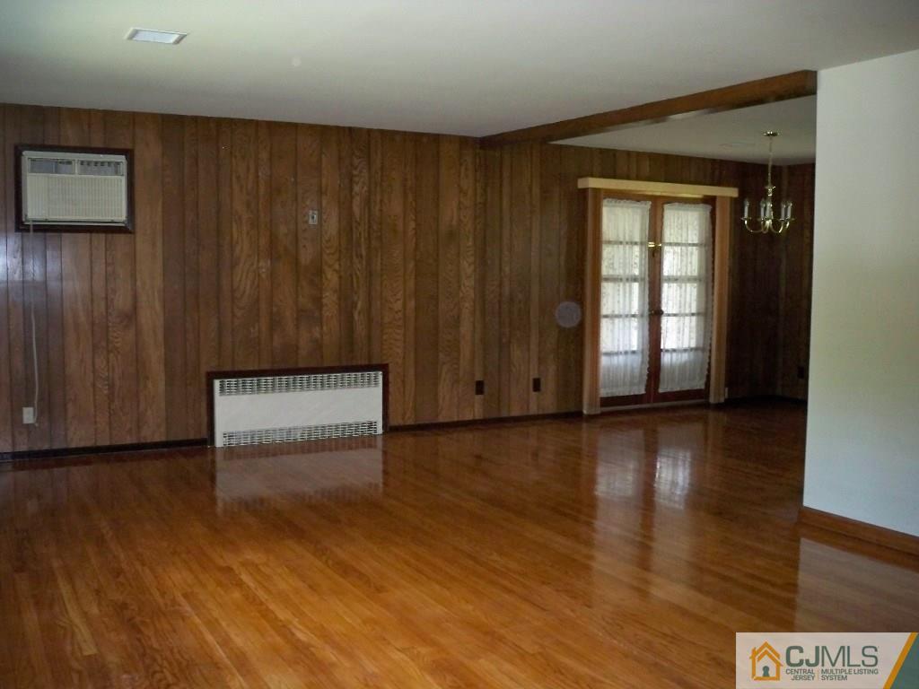 111 Kimberly Road Colonia, NJ 07067 - Photo 2 of 18 an empty room with wooden floor and windows