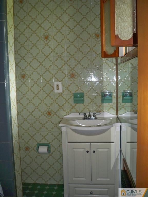 111 Kimberly Road Colonia, NJ 07067 - Photo 11 of 18 a bathroom with a sink and a mirror