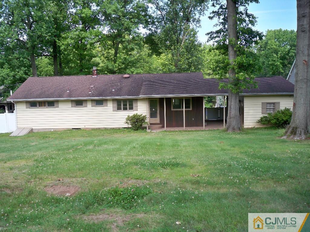 111 Kimberly Road Colonia, NJ 07067 - Photo 17 of 18 a front view of a house with a garden and trees