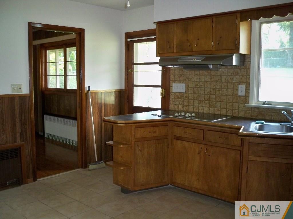 111 Kimberly Road Colonia, NJ 07067 - Photo 5 of 18 a kitchen with a sink and refrigerator