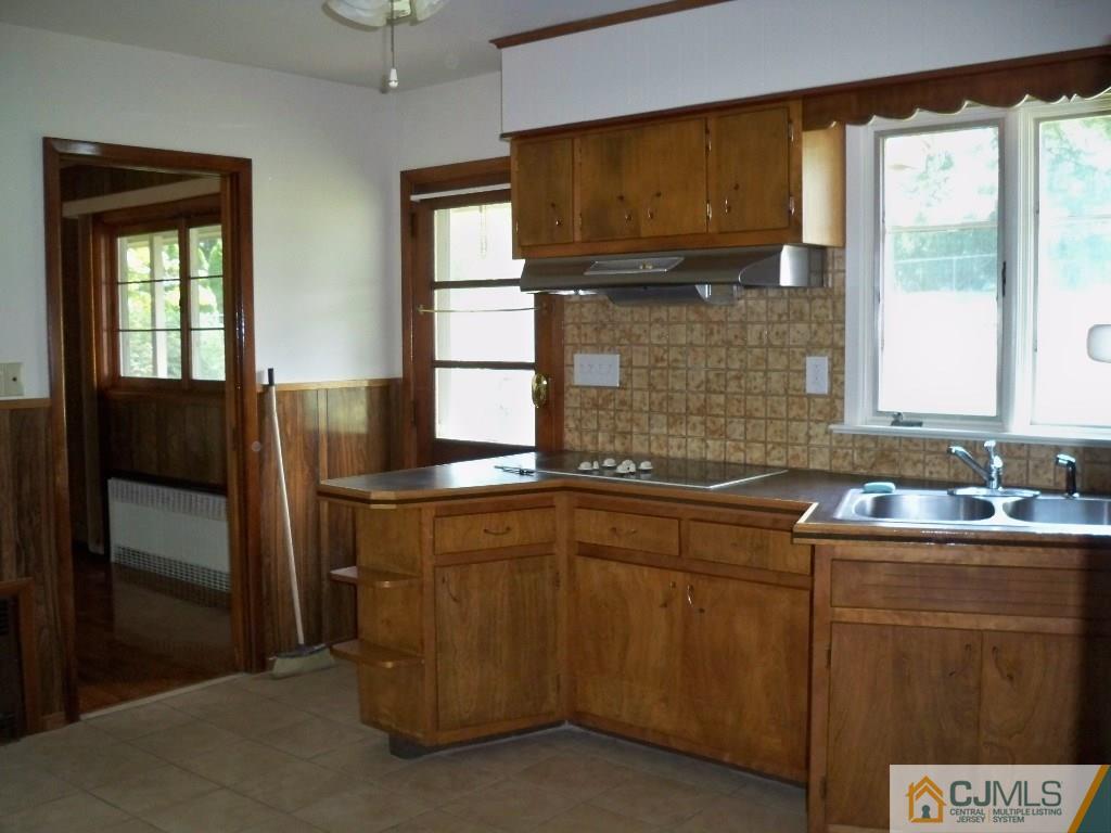 111 Kimberly Road Colonia, NJ 07067 - Photo 7 of 18 a kitchen that has a sink and a stove in it