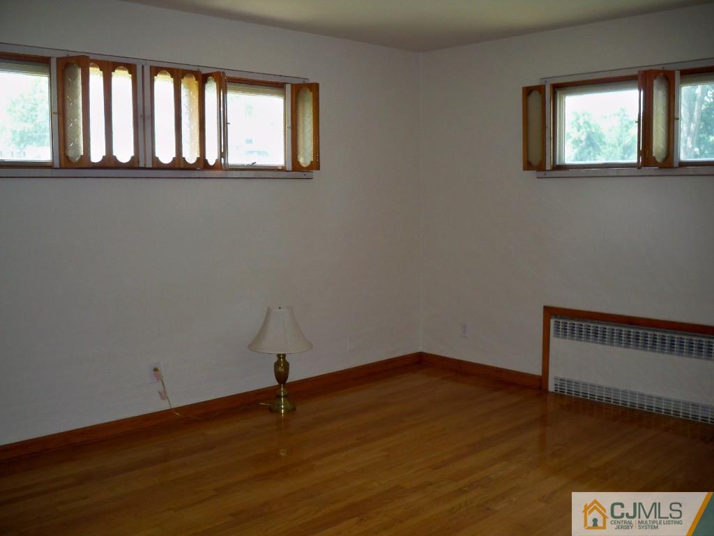 111 Kimberly Road Colonia, NJ 07067 - Photo 10 of 18 a view of an empty room with wooden floor and a window