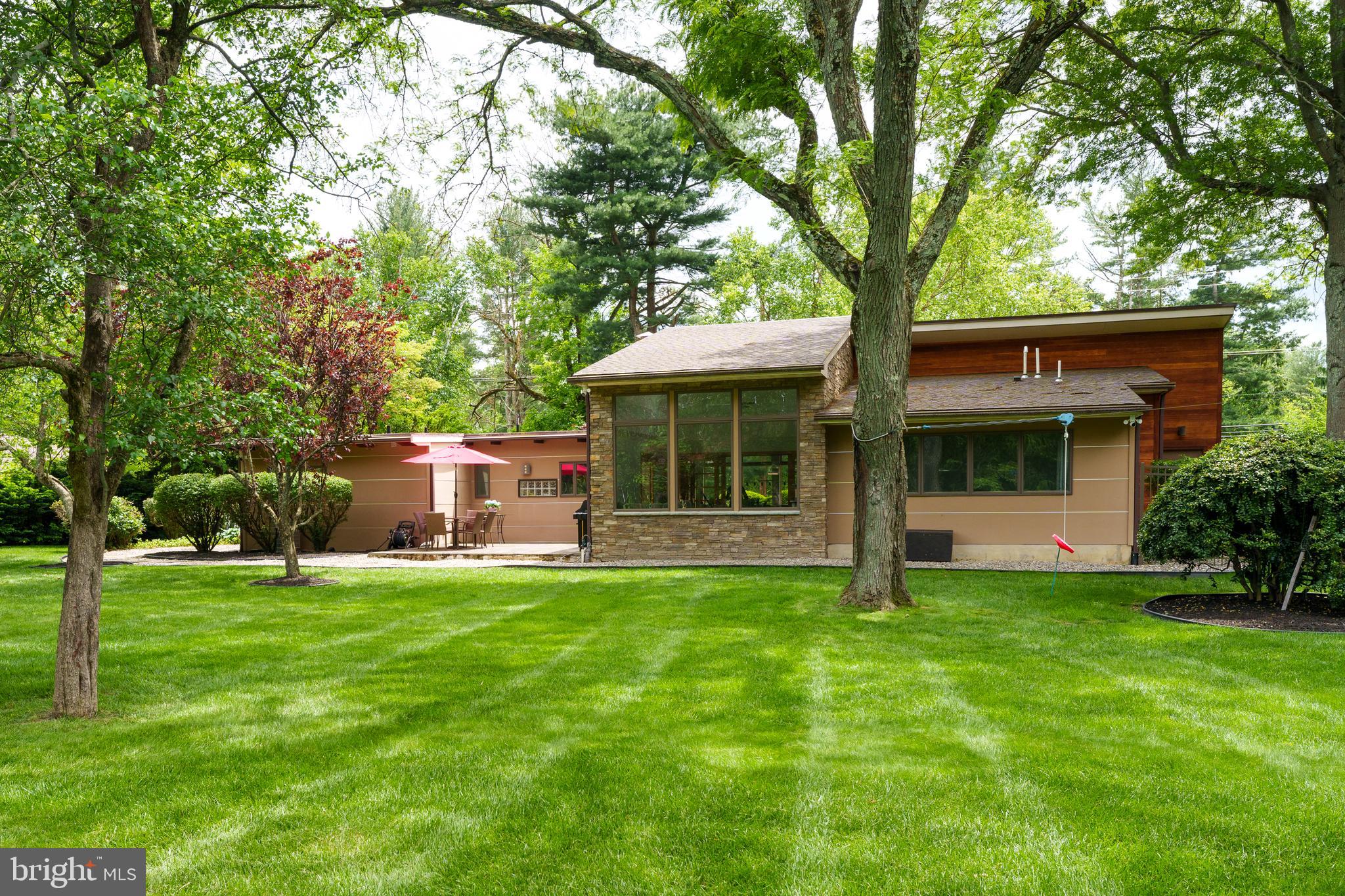319 Clarksville Road Princeton Junction, NJ 08550 - Photo 7 of 41 a front view of a house with a garden and trees