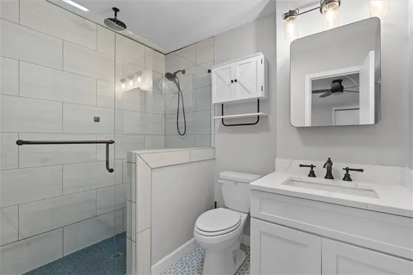 a bathroom with a toilet sink and shower