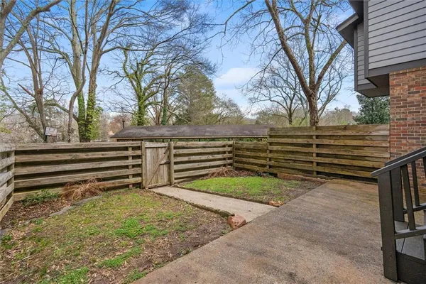a view of a backyard with a large tree