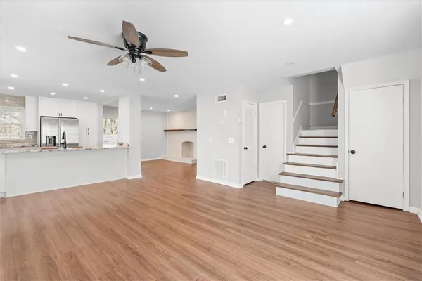a view of a kitchen with wooden floor and a kitchen
