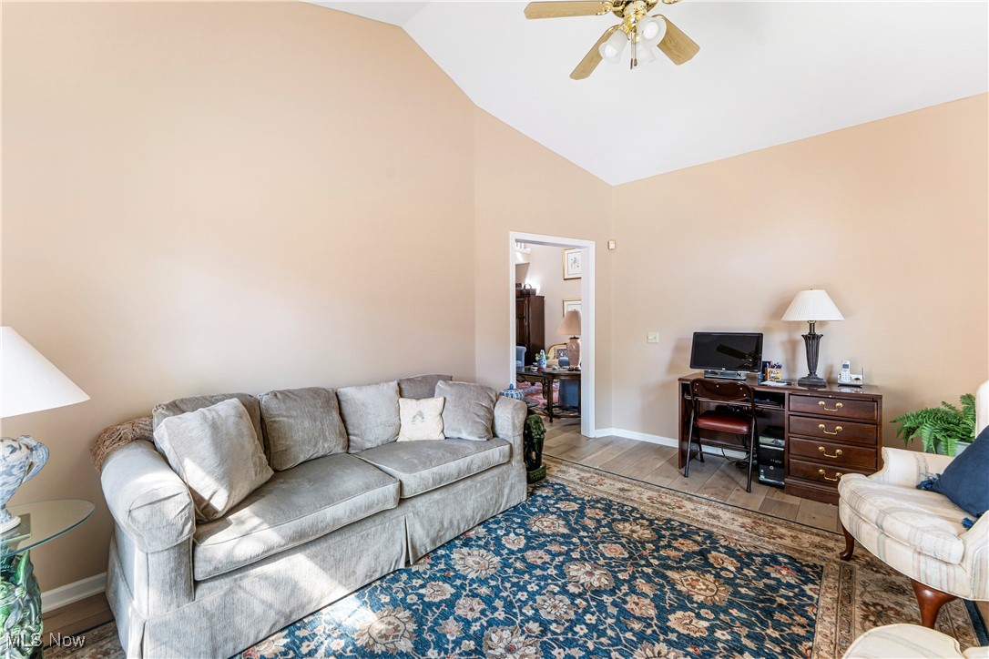 2444 Charing Cross Road Northwest Canton, OH 44708 - Photo 15 of 40 Living room with vaulted ceiling, ceiling fan, and light wood-type flooring