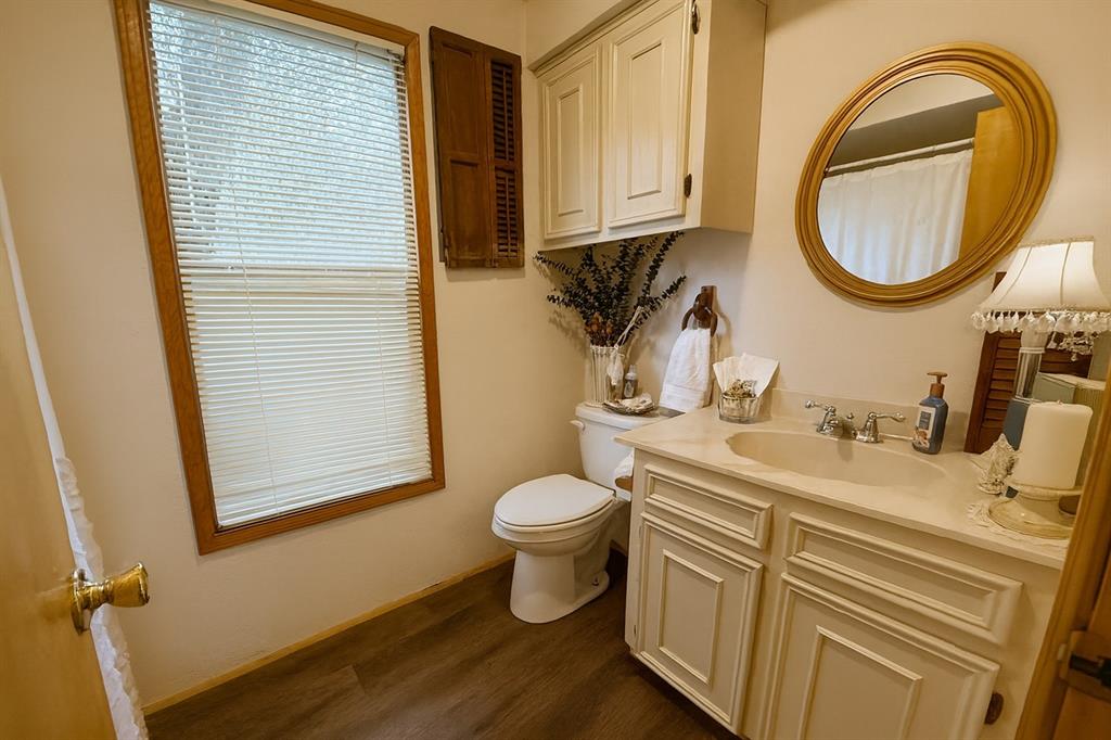 314 Cockerell Street Eustace, TX 75124 - Photo 10 of 15 Bathroom with vanity, a shower with curtain, and dark wood-style flooring