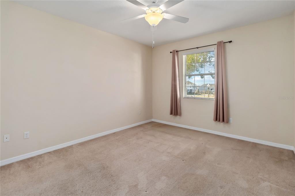 1379 Vasey Road Apopka, FL 32703 - Photo 11 of 21 an empty room with windows and fan
