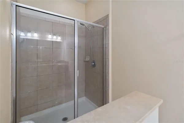 a bathroom with a glass shower door
