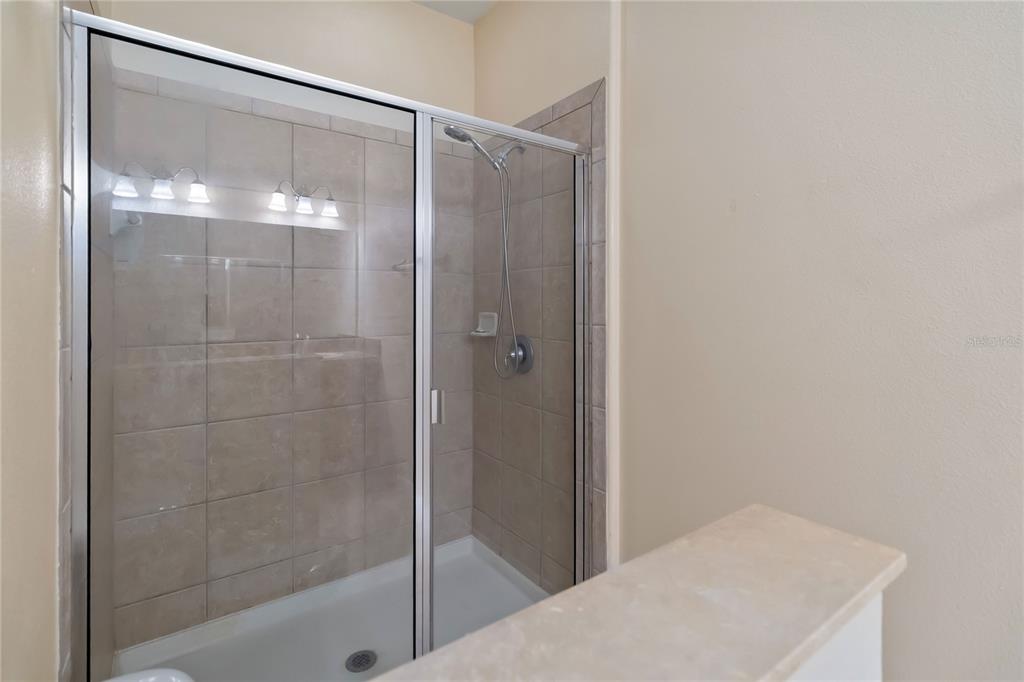 1379 Vasey Road Apopka, FL 32703 - Photo 13 of 21 a bathroom with a glass shower door