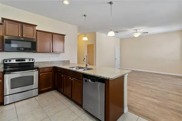 a kitchen with a sink and a stove top oven