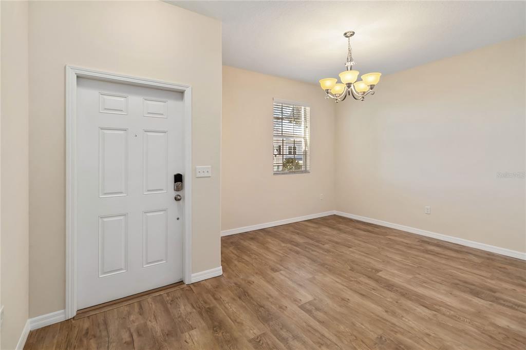1379 Vasey Road Apopka, FL 32703 - Photo 5 of 21 wooden floor in an empty room with a window