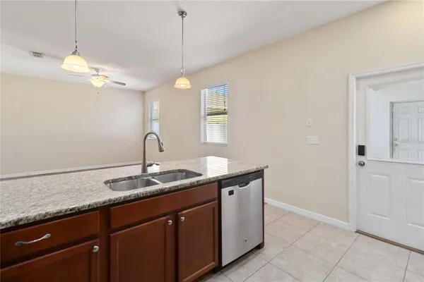 a kitchen with a sink and chandelier
