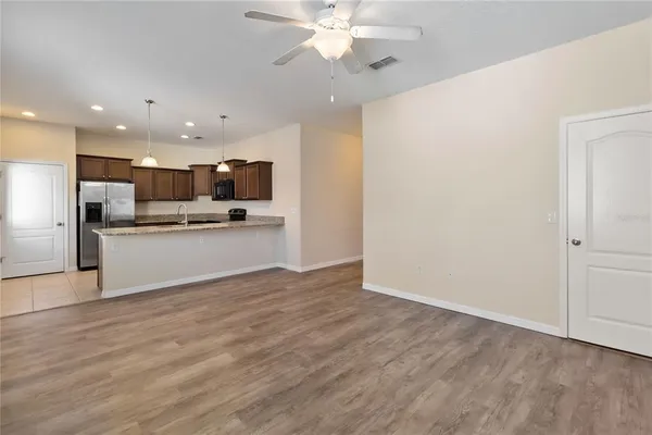 a view of kitchen with granite countertop cabinets and stainless steel appliances